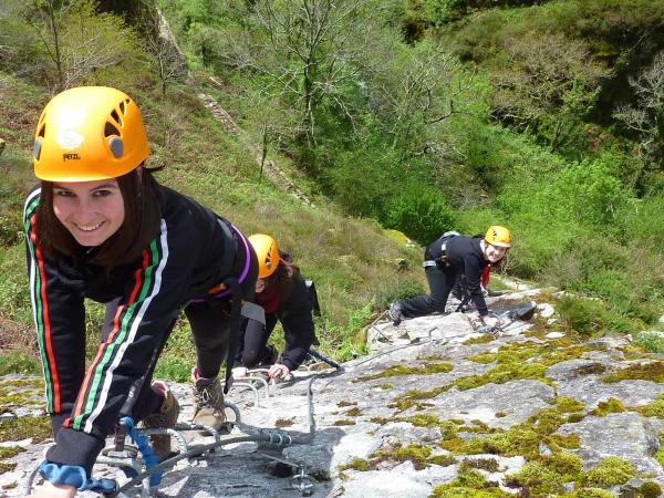 Three girls climbing rock